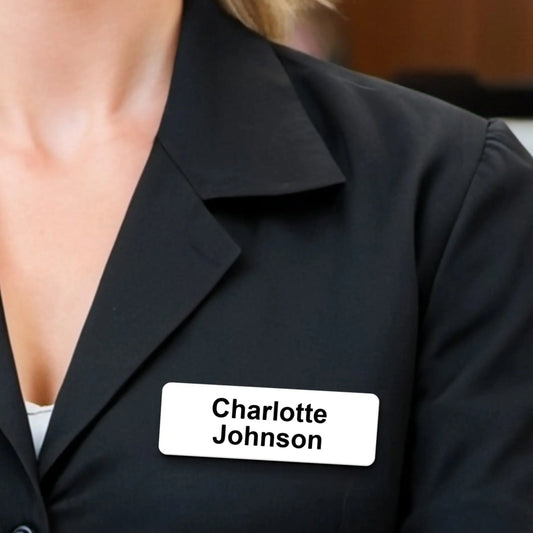 Executive wearing a white name tag with black text